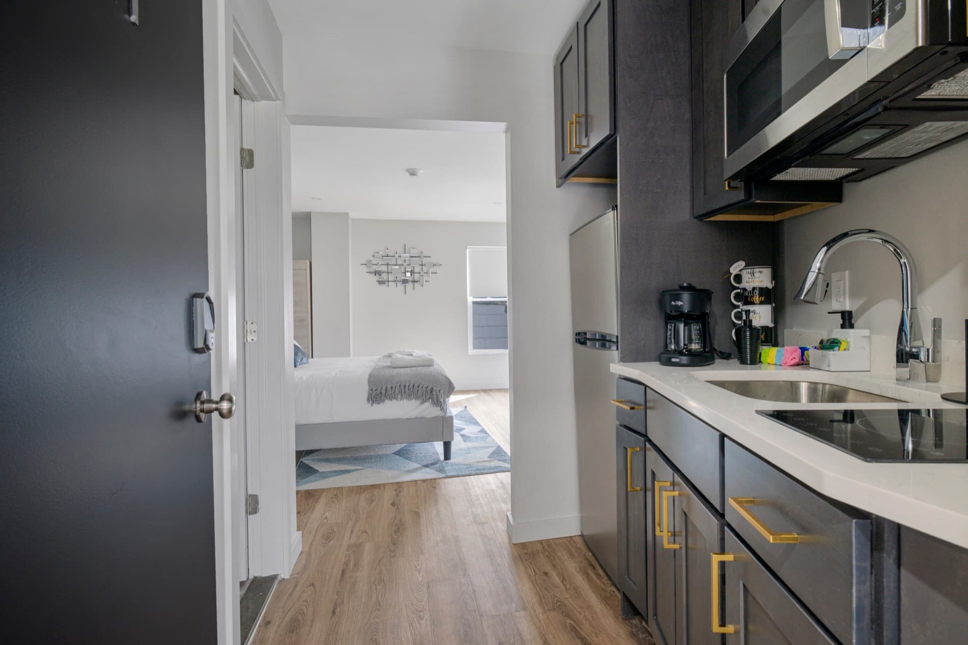 A restored suite at The Columbus Hotel, a galley kitchenette leading into a bedroom