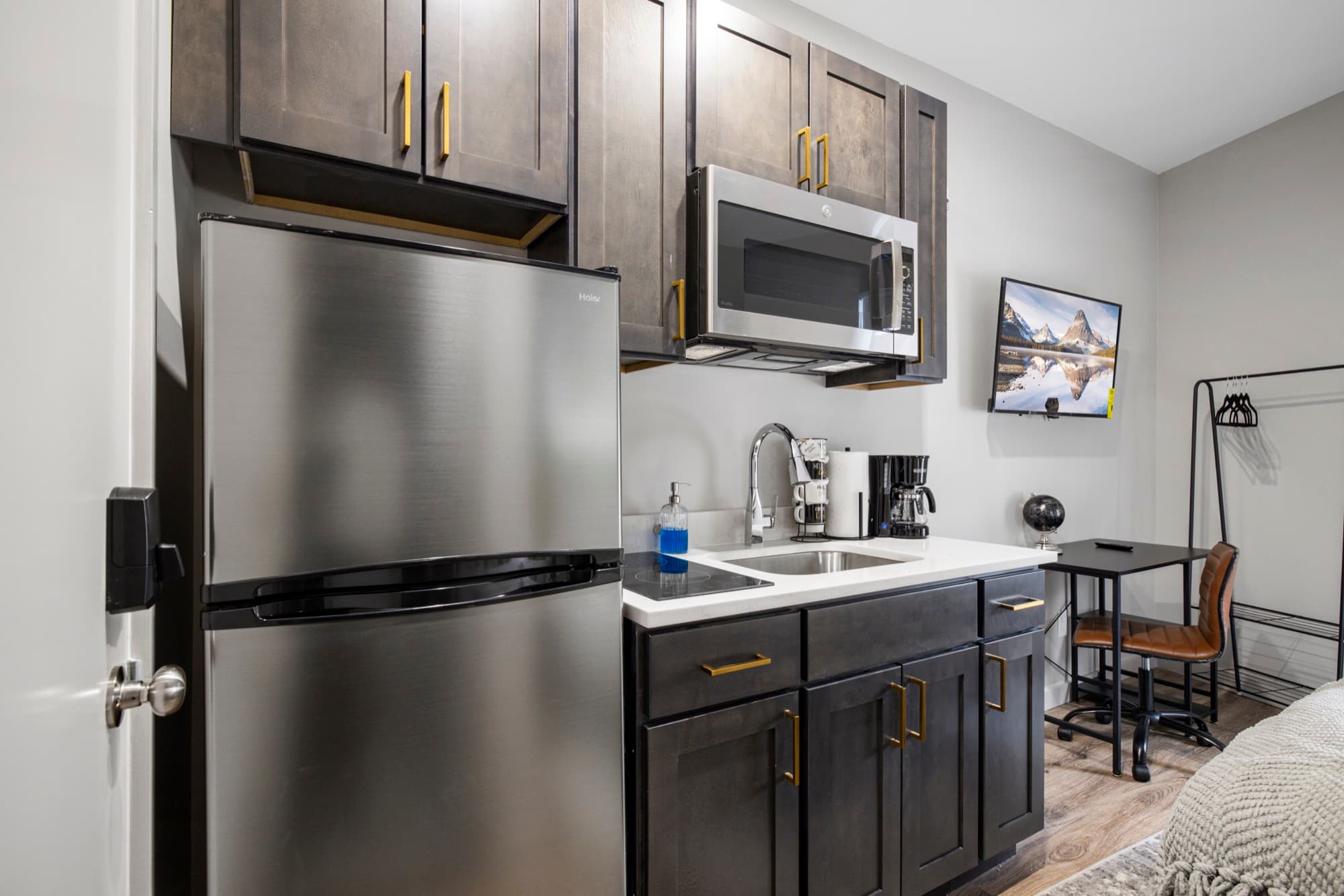 Kitchenette with slate cabinets and stainless appliances